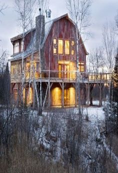 a large red house sitting on top of a snow covered field