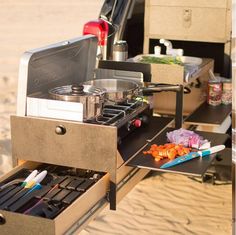 an outdoor cooking station with utensils and food