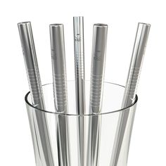 four silver pens in a clear glass cup