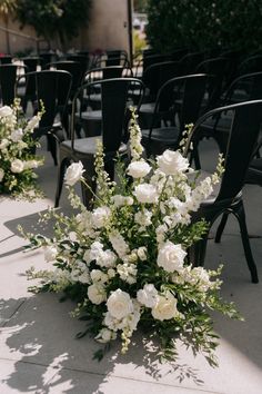 a bunch of chairs that have flowers in them