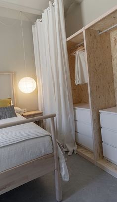 a white bed sitting next to a closet in a bedroom