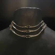 "Lead-free pewter cast chicken bone chokers. Each bone bar is 4\" x ¼\" Adjustable 14\" - 16\" See this listing for interchangeable pendant versions. https://www.etsy.com/listing/1204160736/bone-chokers-with-interchangeable?click_key=cc61314a71a59c20aee60a000413187b23f41fbe%3A1204160736&click_sum=a9392cb3&ref=shop_home_active_1&frs=1 Always ethically sourced bones. Nothing has ever been harmed for the purpose of our jewelry. All pieces are made-to-order despite the \"in stock\" number in the lis Animal Bone Jewelry Wire, Pewter Casting Jewellery, Bone Jewelry Aesthetic, Unique Metal Clavicle Chain Choker, Adjustable Oxidized Choker Jewelry, Unique Metal Choker With Adjustable Chain, Unique Bone-colored Sterling Silver Jewelry, Unique Bone Colored Sterling Silver Jewelry, Unique Adjustable Metal Choker