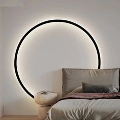 a bedroom with a circular light on the wall