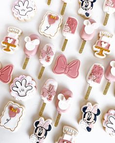 a table topped with lots of decorated cookies and lollipops