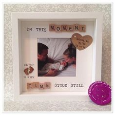 a photo frame with a wooden heart in the middle and words on it that say'in this moment, time stood still '