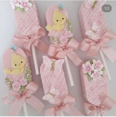 there are many pink candy lollipops decorated with teddy bears and flowers on them