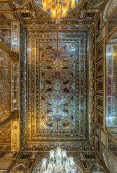 an elaborately decorated ceiling with chandeliers and mirrors in the center is shown