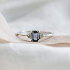 The ring is made in White gold 14K and ready to ship after resizing. Make you proposal with our blue green sapphire engagement ring!  Emerald cut Sapphire ring can be made in minimalist and delicate style.  Please choose the ring size from the variations.  *Ring sizes from 9 US/ 59.5mm are available for extra amount, please contact me before purchase. Product details: Diamonds: Shape - Round                 Size - 1.25mm Q-ty - 6 Clarity - SI1 Color - G Carat weight - 0.06ct Origin - Natural Sap Sapphire Engagement Ring Emerald Cut, Blue Green Sapphire Engagement Ring, Emerald Cut Sapphire Ring, Sapphire Cluster Ring, Montana Sapphire Engagement Ring, Engagement Ring Emerald Cut, Engagement Ring Emerald, Green Sapphire Engagement, Green Sapphire Engagement Ring