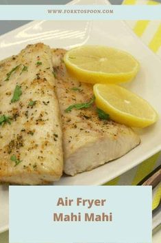 air fryer mahi mahi on a plate with lemons and parsley