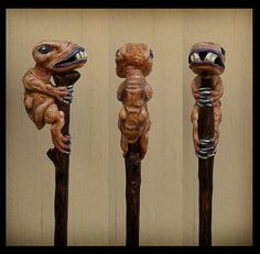 four carved wooden poles with animals on them