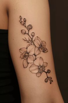 a black and white flower tattoo on the right thigh, with flowers growing out of it