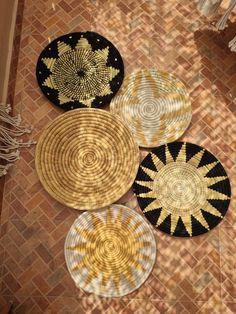 four woven baskets are arranged on the floor