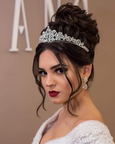 a woman wearing a tiara and red lipstick