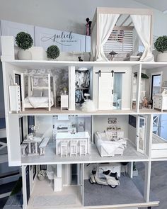 a doll house with all white furniture and accessories