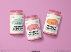 three bottles of modern glow co on a pink background