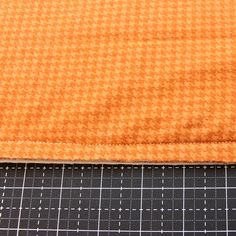 an orange piece of cloth next to a ruler