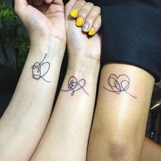 two women with matching tattoos on their arms