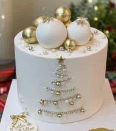 a white cake with gold ornaments on top