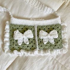 a crocheted purse with two bows on it