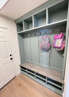 a wooden bench sitting next to a white door in a room filled with bookshelves