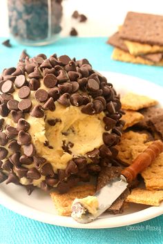 a chocolate chip ice cream sandwich on a white plate with a knife and cookie crumbs