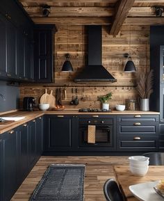 a kitchen with wooden walls and black cabinets