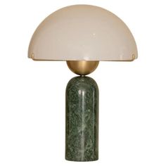 a green marble lamp with a white shade