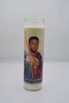 a candle with an image of jesus holding a bow