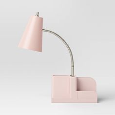 a pink desk lamp with a light on the side and a white base behind it