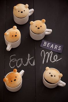 there are four bears in mugs on the table