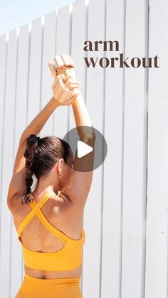 a woman in a yellow sports bra top stretching her arms with the words arm workout