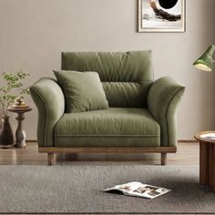 a living room with a green chair and coffee table