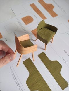 a person is making miniature chairs out of wood