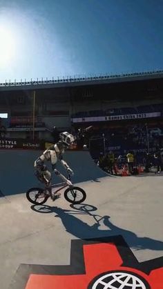 a man riding a bike down the side of a ramp