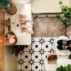 a person is sitting on the toilet with their feet in the bowl next to it