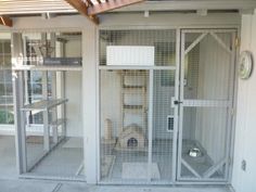 the inside of a caged in bird house with several cages on top of it