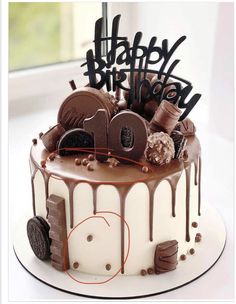 a birthday cake with chocolate icing and decorations