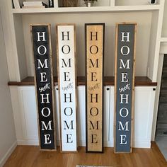 three wooden signs that say home, hope, comfort and support are on the floor in front of a bookcase