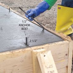 a man in blue gloves is working on a beam