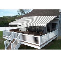 a white deck with an awning over it