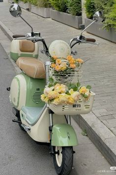 a scooter with flowers in the basket is parked on the street