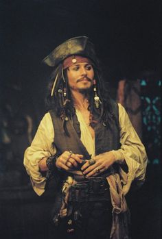 a man dressed in pirate clothing with a hat and eye patch