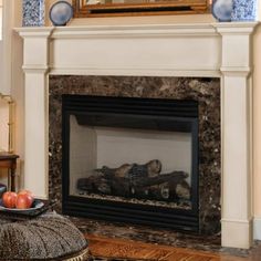 a living room with a fire place and a mirror on the wall above it's mantle