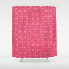 a pink shower curtain with hearts on it