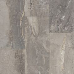 a tile floor with different colors and patterns on it's surface, including grey marble