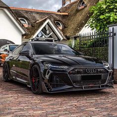 an audi sports car parked in front of a house