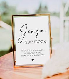 a guest book sitting on top of a wooden table