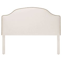 an upholstered white headboard with gold trimmings on the top and bottom