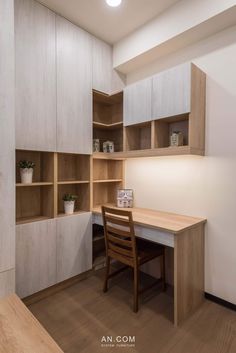 an office with white cabinets and wooden desk in the center, along with a wood chair