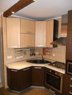 a kitchen with wooden cabinets and white counter tops